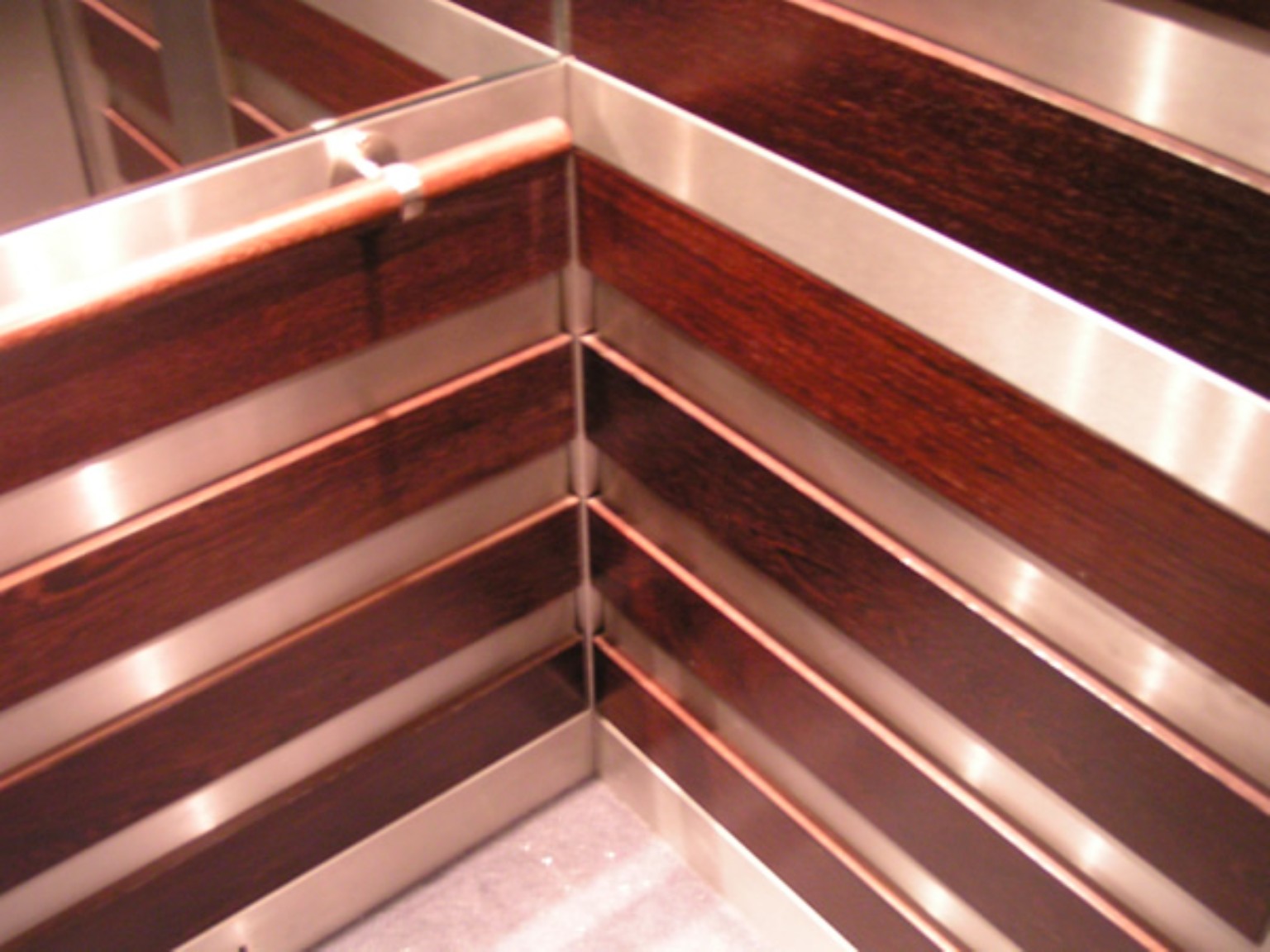 Copper-toned decorative lift interior detail